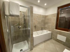 a bathroom with a shower and a bath tub at Villa Vittoria in Erba
