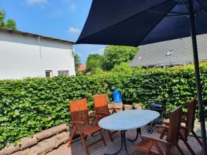 a table and chairs with an umbrella on a patio at Ostssespitze in Riepsdorf