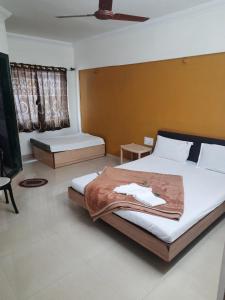 Postel nebo postele na pokoji v ubytování HOTEL S K PALACE
