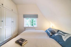 a small bedroom with a bed and a window at Altes Schulmeisterhaus Wohnung 2 in Oevenum