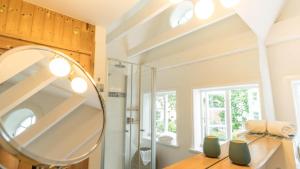 a bathroom with a mirror and a sink at Altes Schulmeisterhaus Wohnung 2 in Oevenum +26 photos