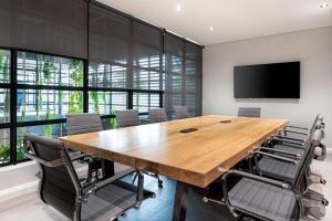 a conference room with a large wooden table and chairs at Harvil House in George
