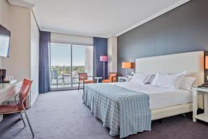 Ein Bett oder Betten in einem Zimmer der Unterkunft Hotel Balneario Playa de Comarruga