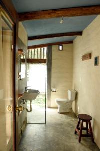 a bathroom with a sink and a toilet at Avalon Hostal Boutique in Vilcabamba