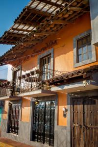 a building with a balcony and a door at La Escondida Hotel Boutique in Zacatlán
