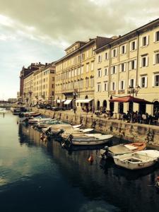 a group of boats docked in the water next to buildings at Hotel Centrale in Trieste