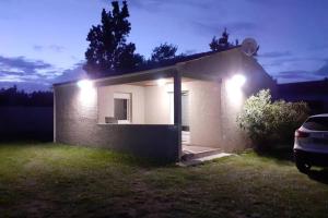 a small house with lights on the side of it at Maison vacances d'Oléron in La Brée-les-Bains
