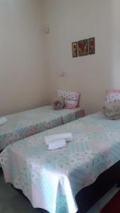 a bedroom with two beds with towels on it at Sítio Santa Terezinha Canastra in São João Batista do Glória +80 photos