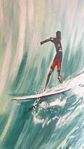 a painting of a man riding a wave on a surfboard at Red Star Surf & Yoga Camp Lanzarote in Famara