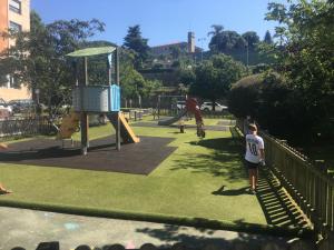 a group of children playing in a playground at Petit con piscina in Pontevedra