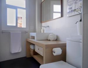 a bathroom with a sink and a toilet at Stay U-nique Apartments Monec in Barcelona