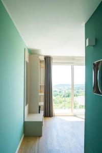 a room with a large window with a view at Encanto Agriturismo & Private SPA in Visogliano