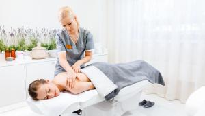 a woman sitting on a patient in a chair at Dorpat Hotel in Tartu