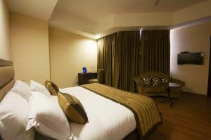 Postel nebo postele na pokoji v ubytování Zenith Hotel - Delhi Airport