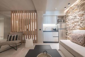 a living room with a couch and a kitchen at Apollonos 28 Luxury Suites in Athens