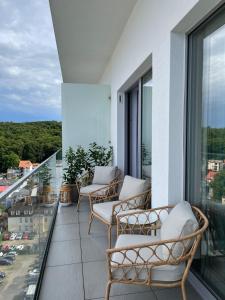 a balcony with chairs and a view of a city at Luksusowy Apartament Blue11 in Międzyzdroje