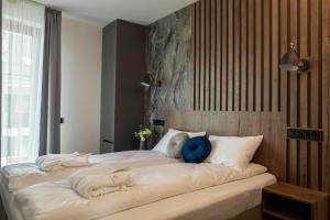 Säng eller sängar i ett rum på Tahiti Resort Apartments Hajdúszoboszló
