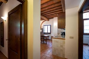 a kitchen with a door and a table in a room at Residence Ristorante La Ferriera in Loro Ciuffenna