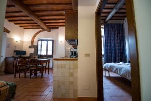 a kitchen and living room with a bed and a table at Residence Ristorante La Ferriera in Loro Ciuffenna