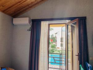 a room with a window and a sliding glass door at Royal Cottage in Ureki