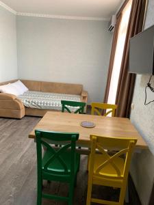 a room with a table and chairs and a couch at Royal Cottage in Ureki