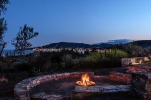 a fire pit in a yard at night at The Olive Yard in Gythio