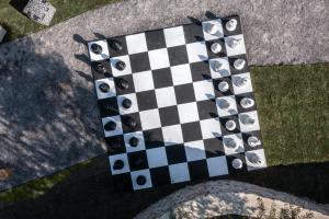 a chess board with eyes on it on the ground at The Olive Yard in Gythio