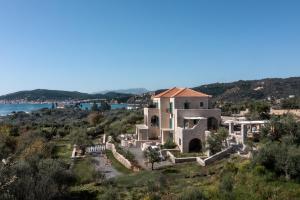 an aerial view of a house on a hill with the ocean at The Olive Yard in Gythio