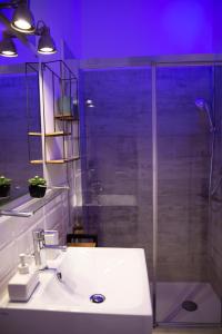 a bathroom with a sink and a glass shower at Villa Volli Three Rooms in Agrigento