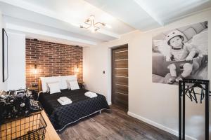 Posteľ alebo postele v izbe v ubytovaní Apartamenty Świętego Jakuba