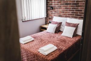 Posteľ alebo postele v izbe v ubytovaní Apartamenty Świętego Jakuba