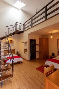 a bedroom with a bunk bed and a staircase at Hotel Casa Merced in Cuenca