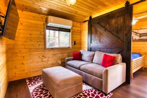 a living room with a couch and a wooden wall at The Base Camp in Spokane