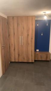 a room with wooden doors and a blue wall at Amazing apartment in Stari Trg pri Ložu