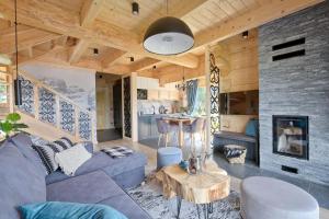 a living room with a couch and a table at Osada Bachledzki Wierch, Odkryj-Zakopane in Zakopane +56 photos