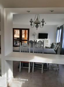 a dining table and chairs in a living room at La Rosa de Tilcara in Tilcara