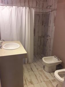 W łazience znajduje się umywalka, toaleta i prysznic. w obiekcie La Rosa de Tilcara w mieście Tilcara
