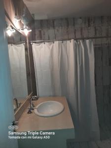 a bathroom with a sink and a mirror at La Rosa de Tilcara in Tilcara