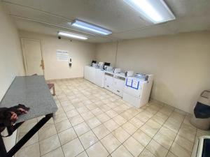 a room with a row of washers and dryers at Motel 6 Oklahoma City OK Fairgrounds West in Oklahoma City