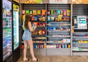 a woman is standing in front of a refrigerator at Surfside Beach Oceanfront Hotel in Myrtle Beach