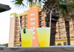 two glasses of yellow drinks sitting on a table at Surfside Beach Oceanfront Hotel in Myrtle Beach