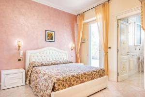 a bedroom with a white bed and a window at Villa Vanessa in Leuca