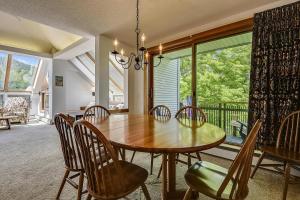 a dining room with a wooden table and chairs at Sunrise Timberline C1 in Killington