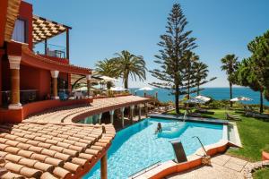 a resort with a swimming pool with a view of the ocean at Boutique Hotel Vivenda Miranda in Lagos