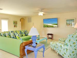 a living room with a couch and a table with a lamp at 438 Kendall Drive in Marco Island