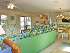 a living room with a couch and a dining room at 438 Kendall Drive in Marco Island