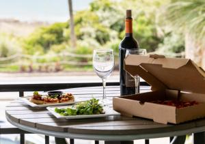 a bottle of wine and a box of food and a glass at Surfside Beach Oceanfront Hotel in Myrtle Beach