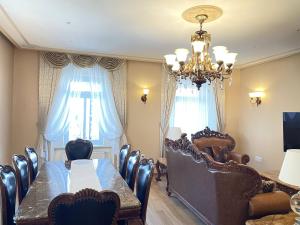 a dining room with a table and chairs and a chandelier at Apartment Ljubljana in Ljubljana