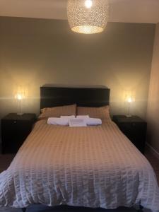 a bedroom with a large bed with two night stands at The Annexe II in Mildenhall