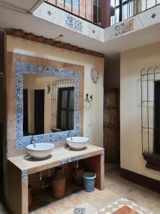 a bathroom with two sinks and a large mirror at Hotel Acatenango Inn in Antigua Guatemala